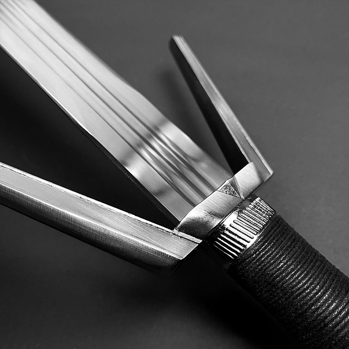 Amphisbaena medieval sword close up of triple fullered blade and angular crossguard with wrapped handle