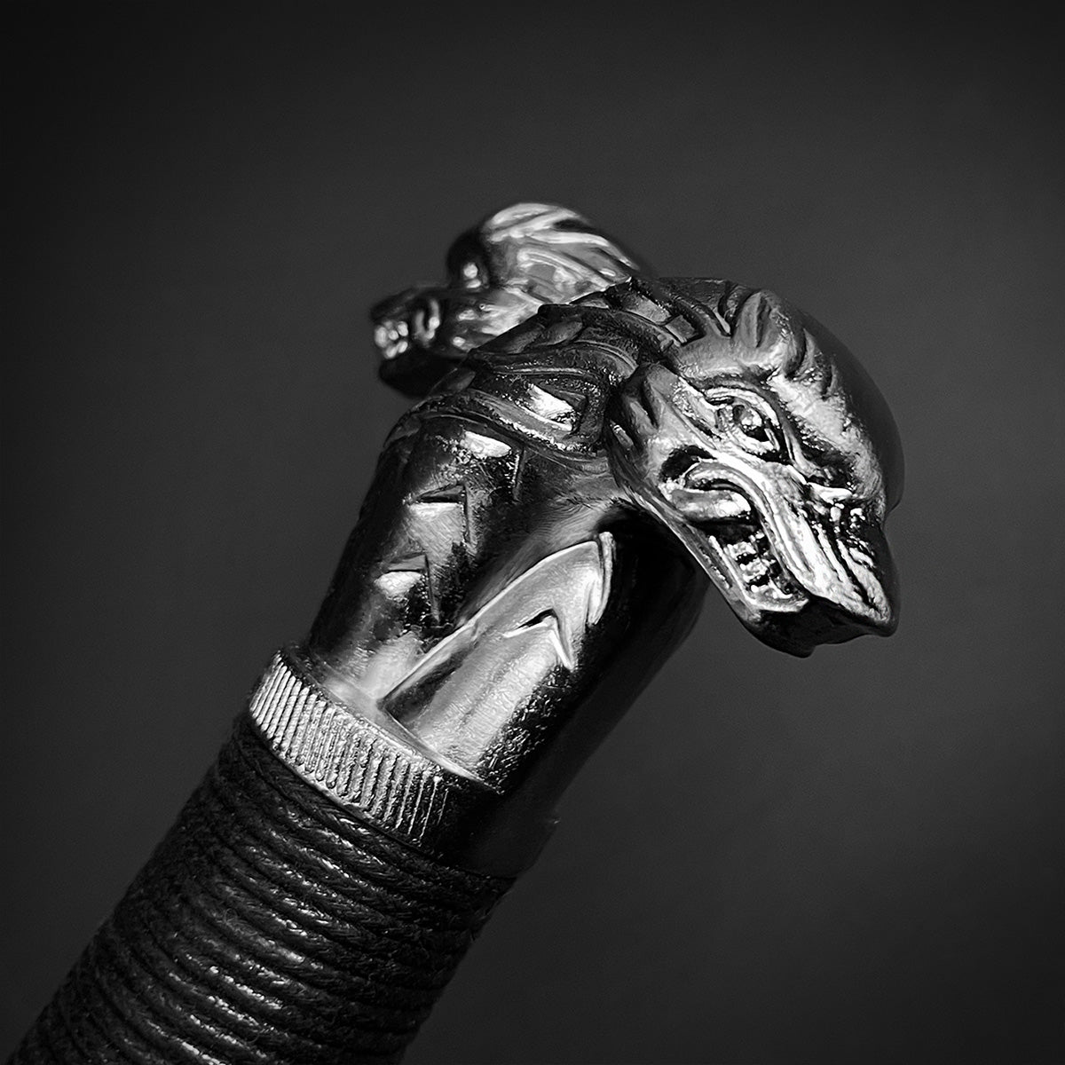 Amphisbaena medieval sword close up of ornate dual headed serpent pommel and wrapped leather grip