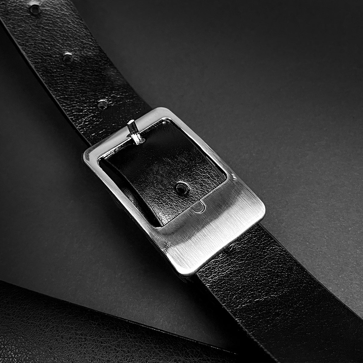 Amphisbaena medieval sword leather belt with silver rectangular buckle close up showing textured black leather