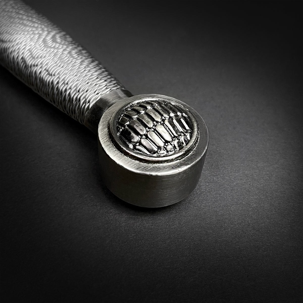 Close-up of the handle of a Chivalry one-hand medieval sword with intricate detailing