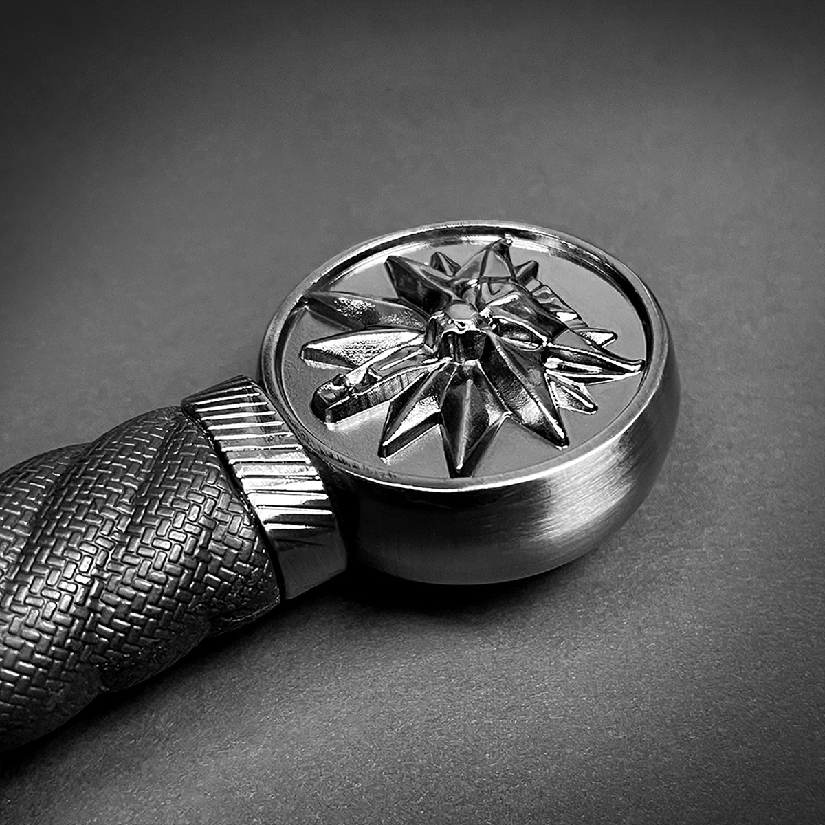 Close-up of collector medieval sword replica pommel with detailed textured grip from Knight's Collection