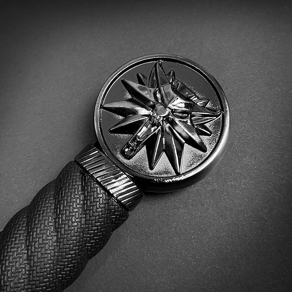 Close-up of a collector medieval sword replica handle with detailed star emblem from Knight's Collection