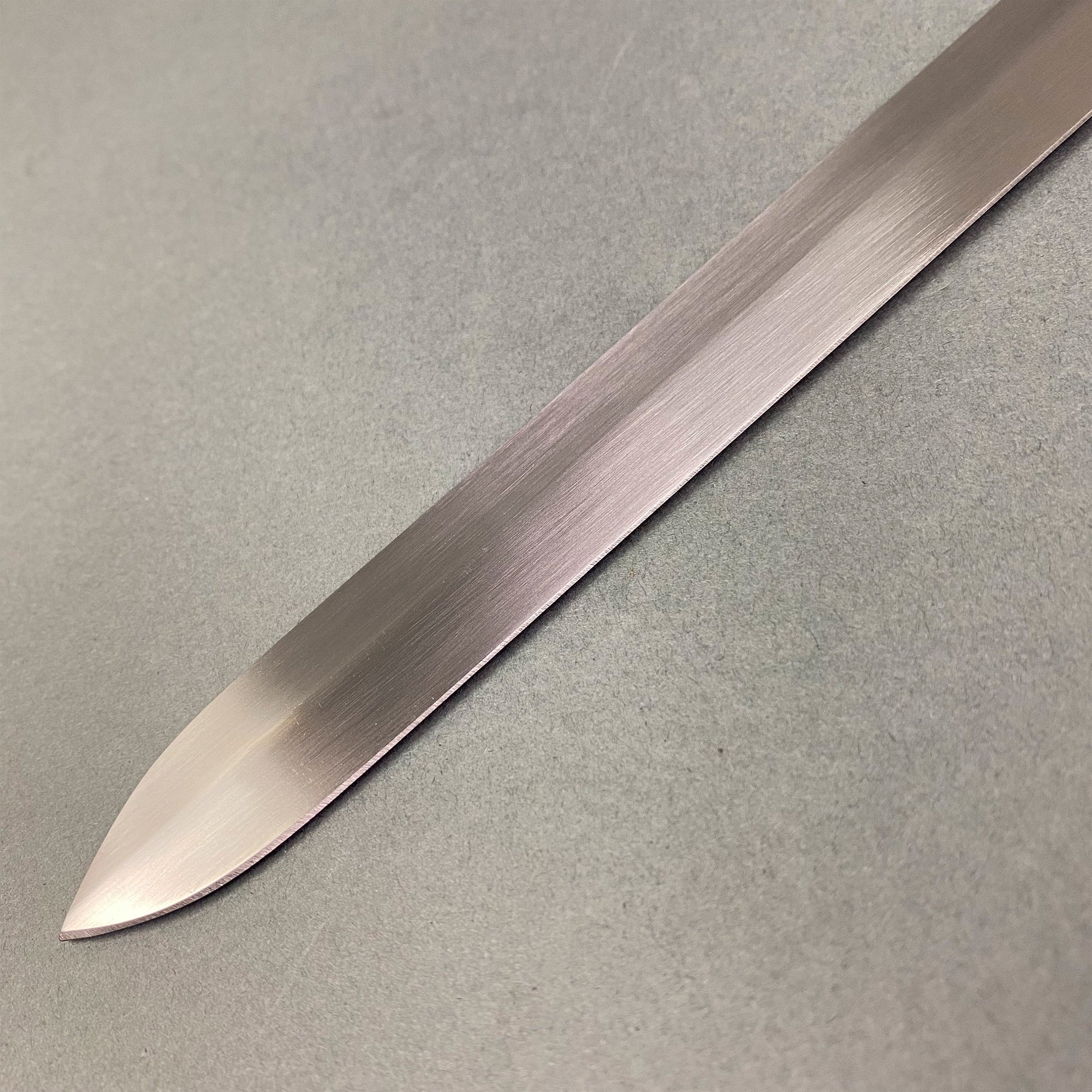 Close-up of hand-forged medieval blade from Knight's Collection one-hand sword showing sharp polished edge