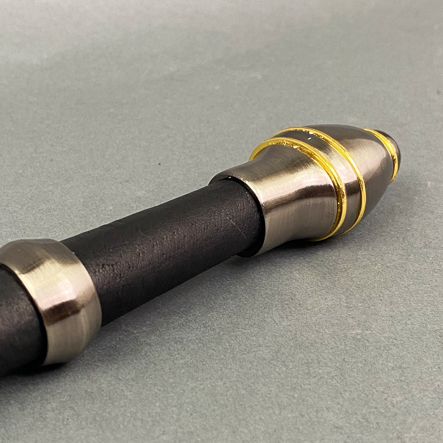 One-Hand Knight Medieval Sword handle with black grip and decorative gold accents for collectors