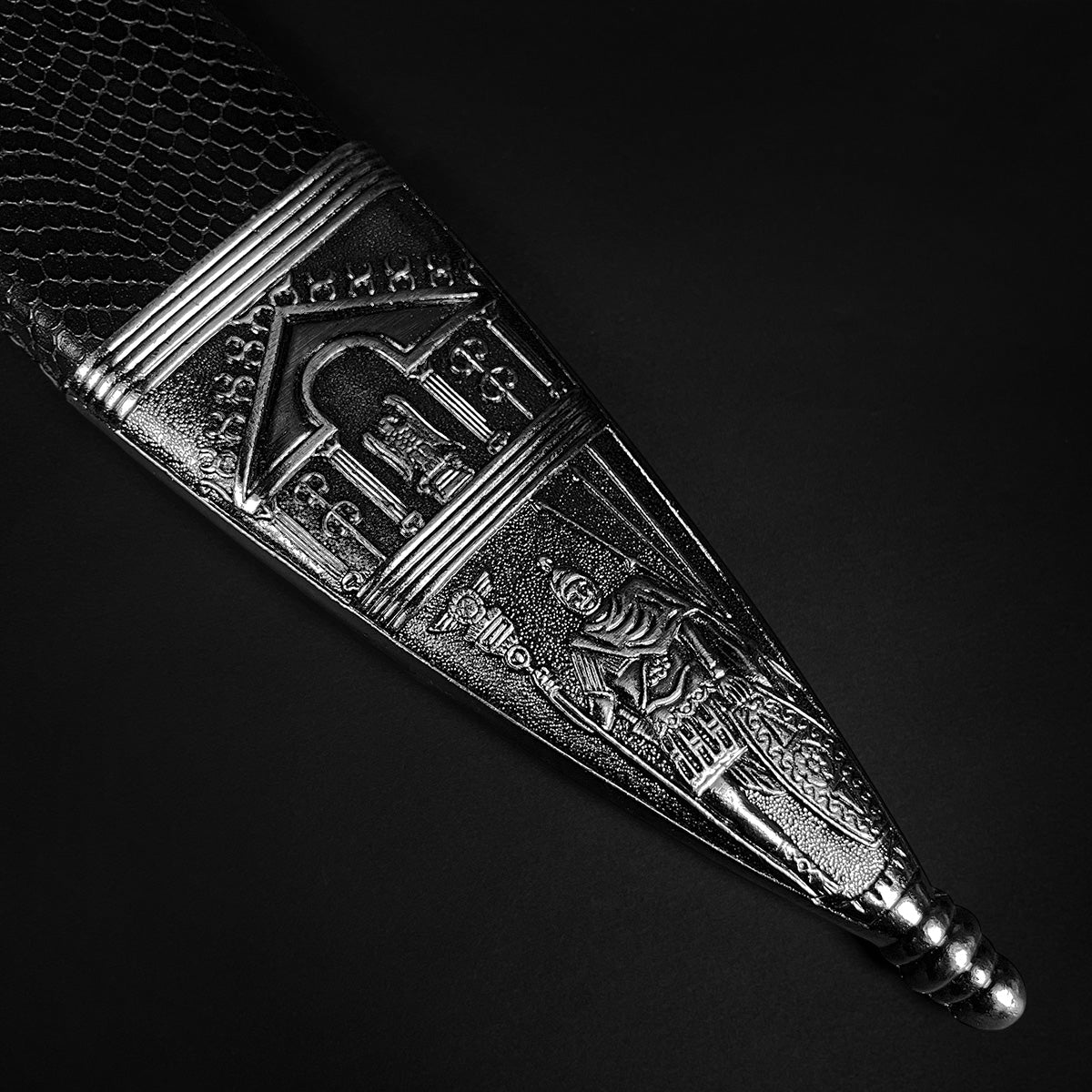 Roman Gladius Medieval Sword ornate silver scabbard close up with embossed Roman scenes on dark background