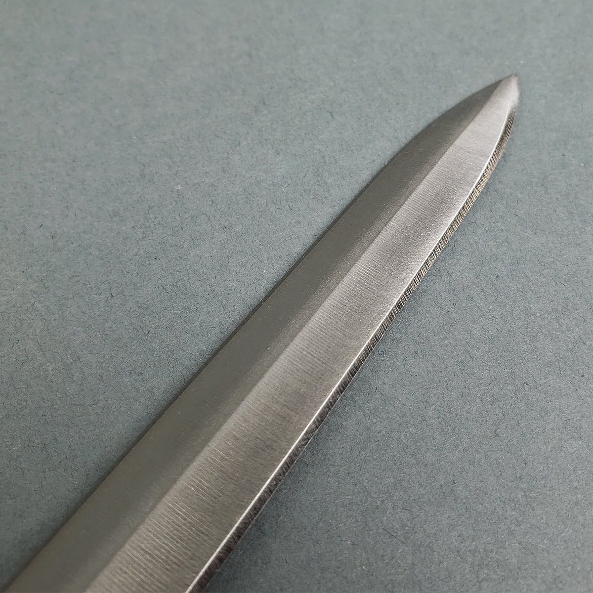 Close-up of a polished blade tip from a Templar sword replica by Knight's Collection