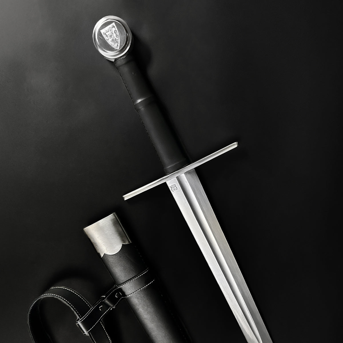 Valebrand hand-forged medieval sword with a sleek blade and ornate hilt, accompanied by a durable leather sheath