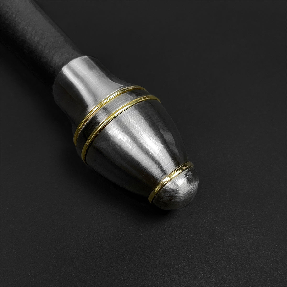 Close-up of polished steel pommel with gold accents on medieval sword for sale from Knight's Collection