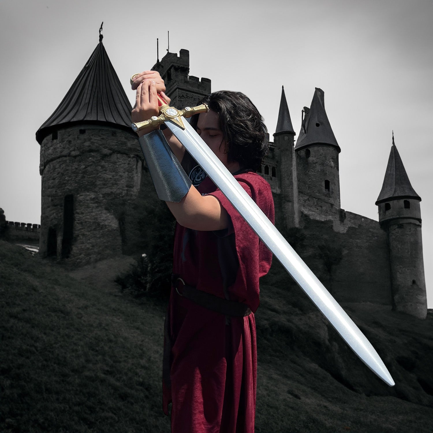 Foam Medieval Swords showcased with a sword raised in front of a castle, ideal for LARP and cosplay events