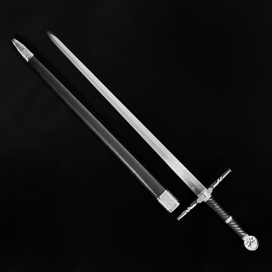 Sword with a decorative hilt on a black background