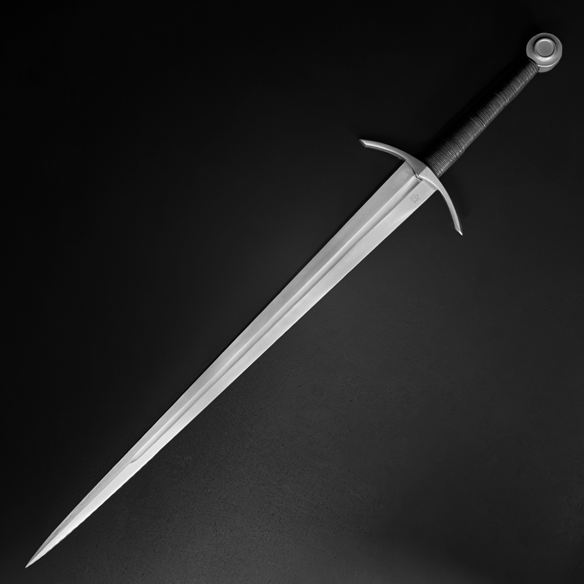 Medieval sword leather-wrapped handle and peened pommel detail