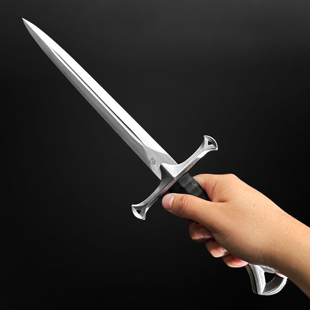 Hand holding a hand-forged dagger 