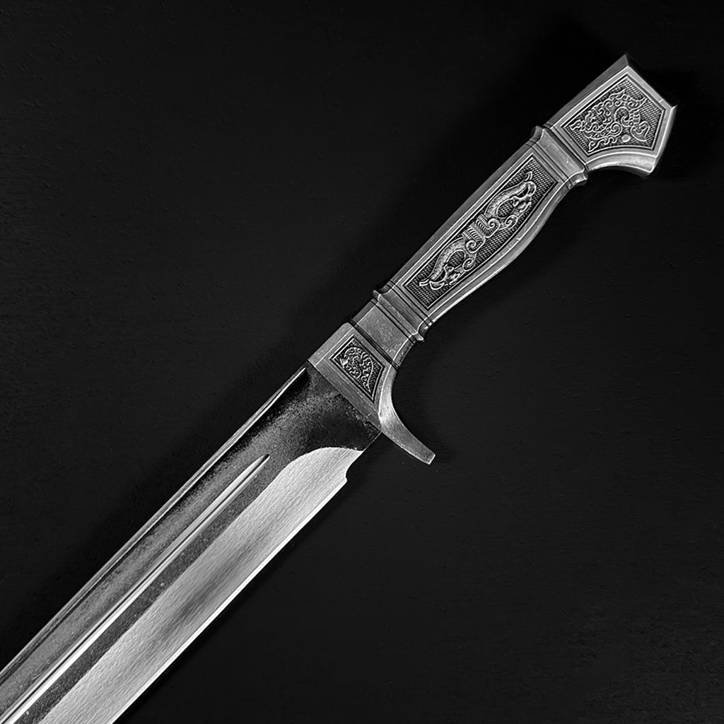 Ornate engraved silver dagger black background | Knight's Collection