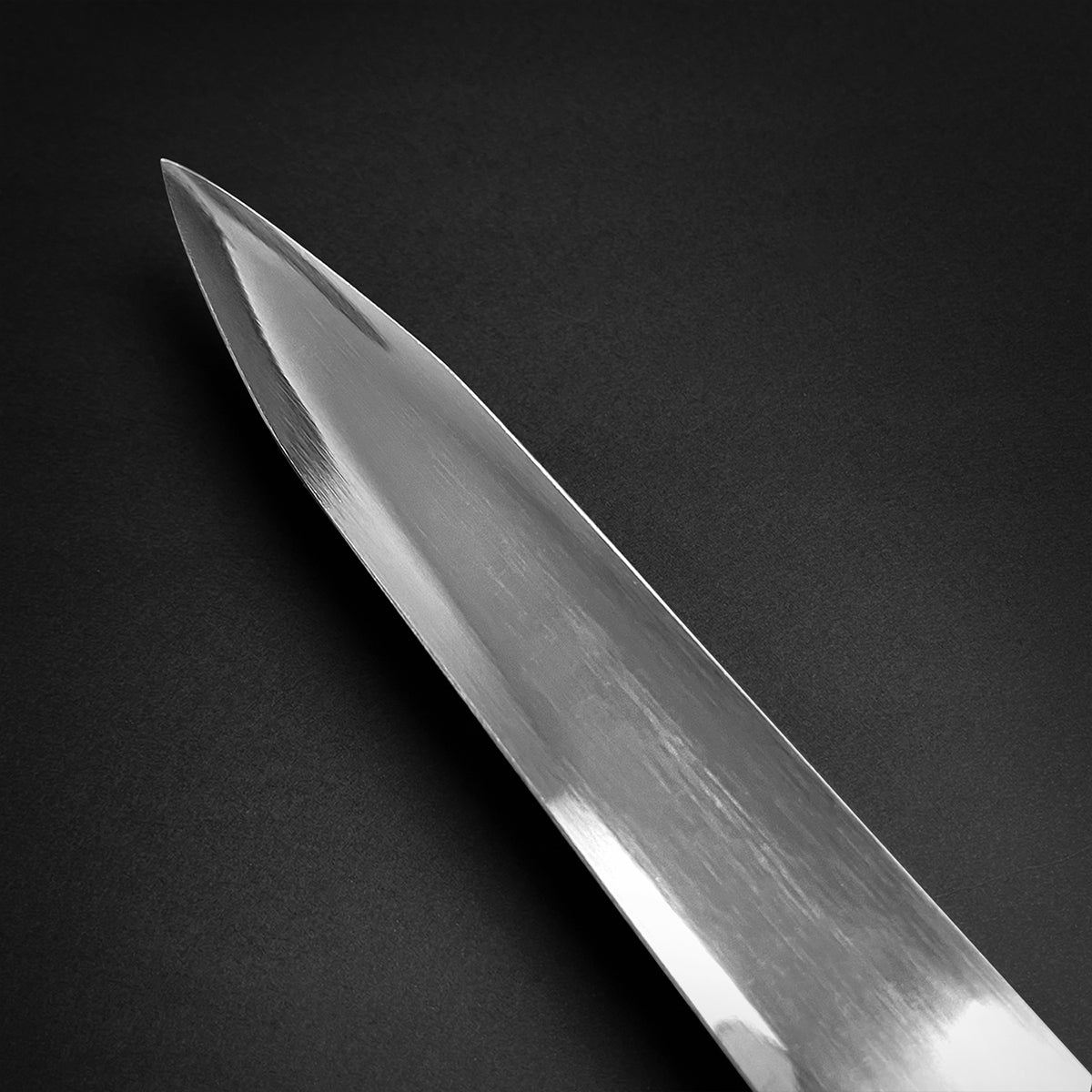 Knights Collection Amphisbaena medieval sword. Polished steel blade close up showing sharp tapered tip