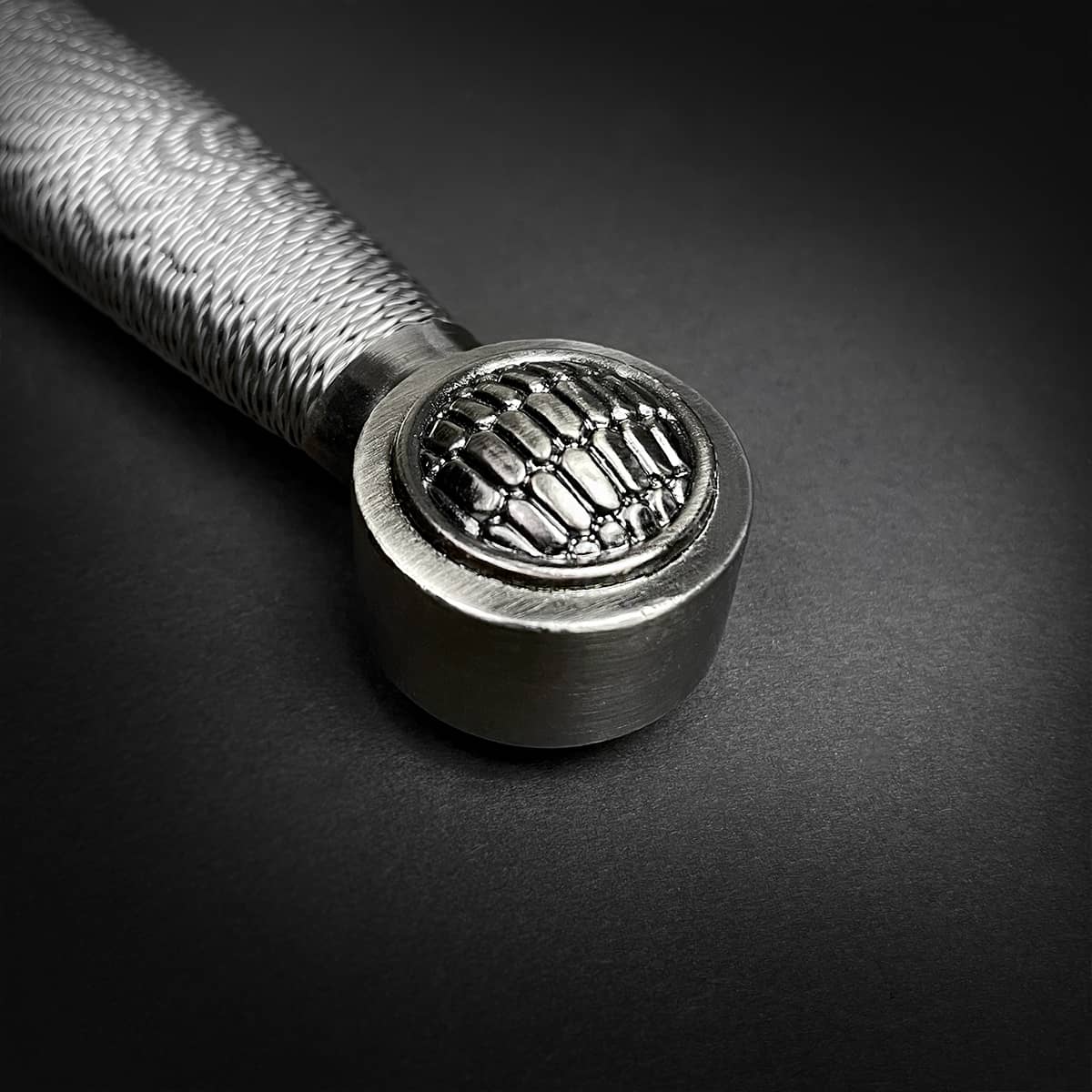 Close-up of the handle of a Chivalry one-hand medieval sword with intricate detailing