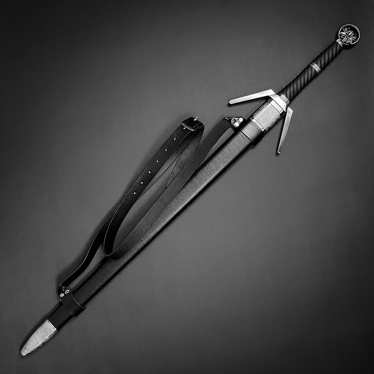 Knight's Collection collector medieval sword replica with black handle and scabbard on dark background