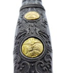 Close-up of decorative Knights Templar medieval sword handle with detailed gold and black engravings