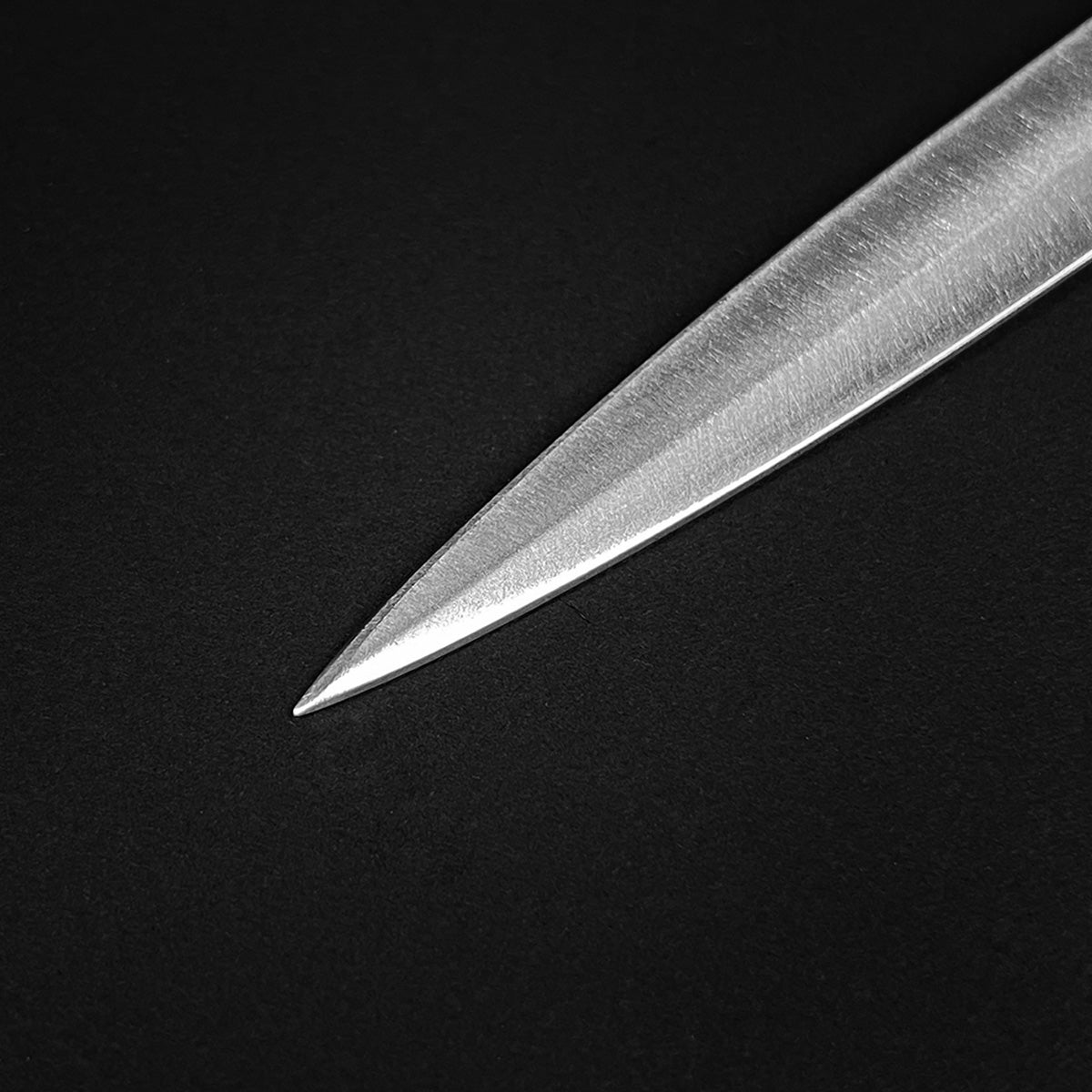 Close-up of Anduril Dagger blade showcasing its sharp, polished edge and sleek design