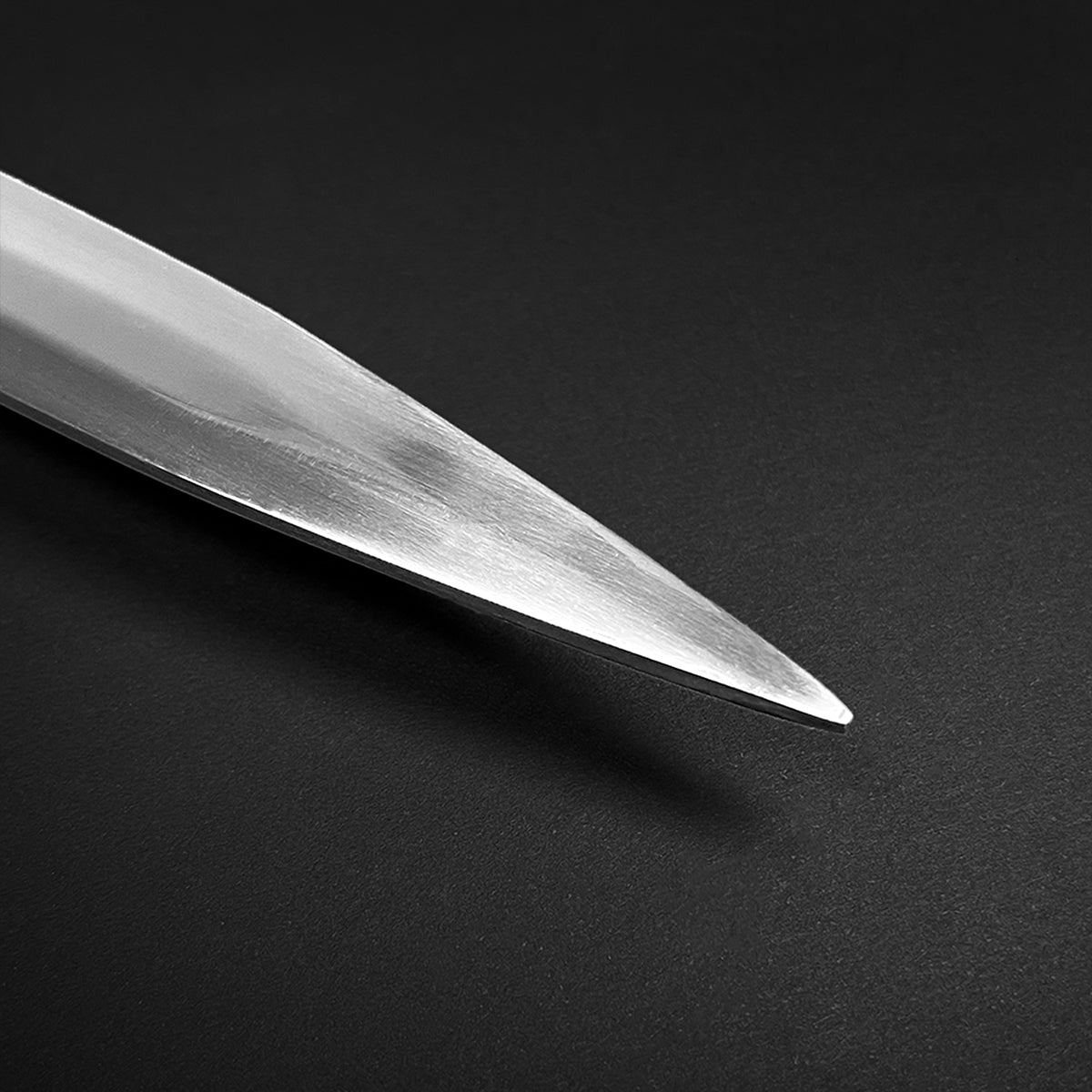 Close-up of the sharp blade tip of a hand-forged battle-ready medieval sword by Knight Collections