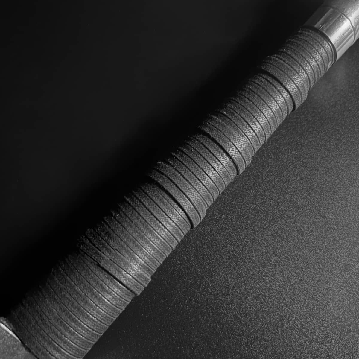 Close-up of a hand-forged medieval knight sword with detailed grip and metal finish