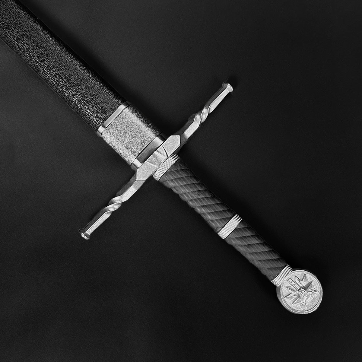 Knight's Collection hand-forged medieval sword with detailed twisted crossguard and textured handle close-up