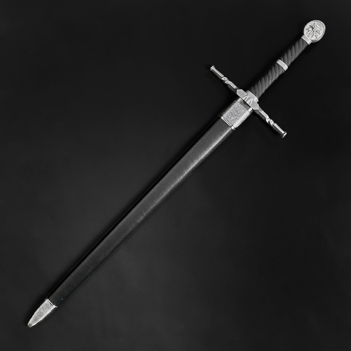 Knight's Collection hand-forged medieval sword with detailed hilt and black scabbard on black background