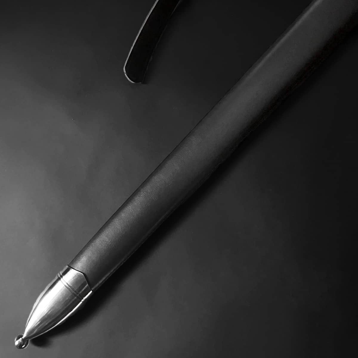 Close-up of Knight's Collection Guardian of Eldwyn Medieval Sword with a sleek black scabbard and polished metal tip