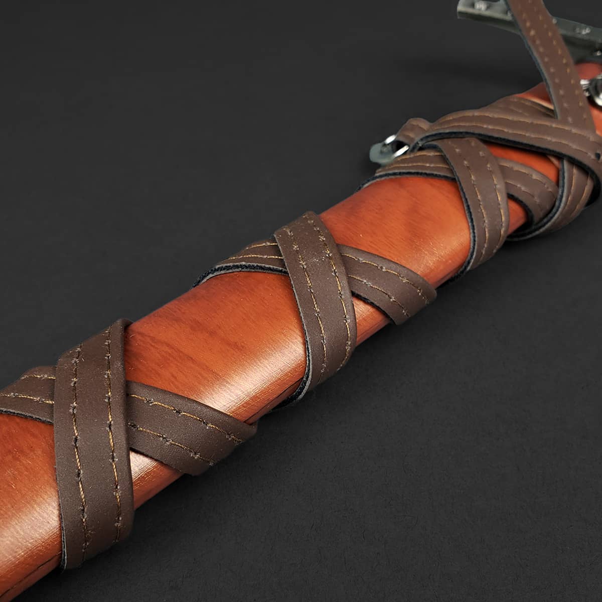 Knights Templar One Hand Short Sword hilt with brown leather grip and intricate lacing detail