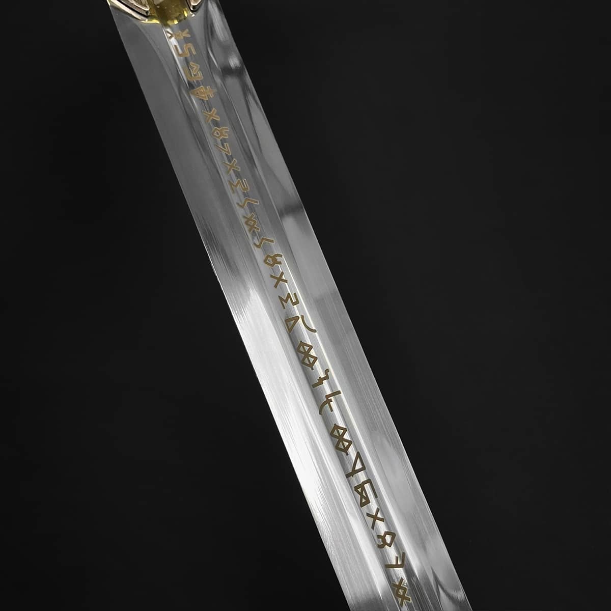 Knights Collection medieval sword for sale polished steel blade with gold rune inlay and partial hilt on black background