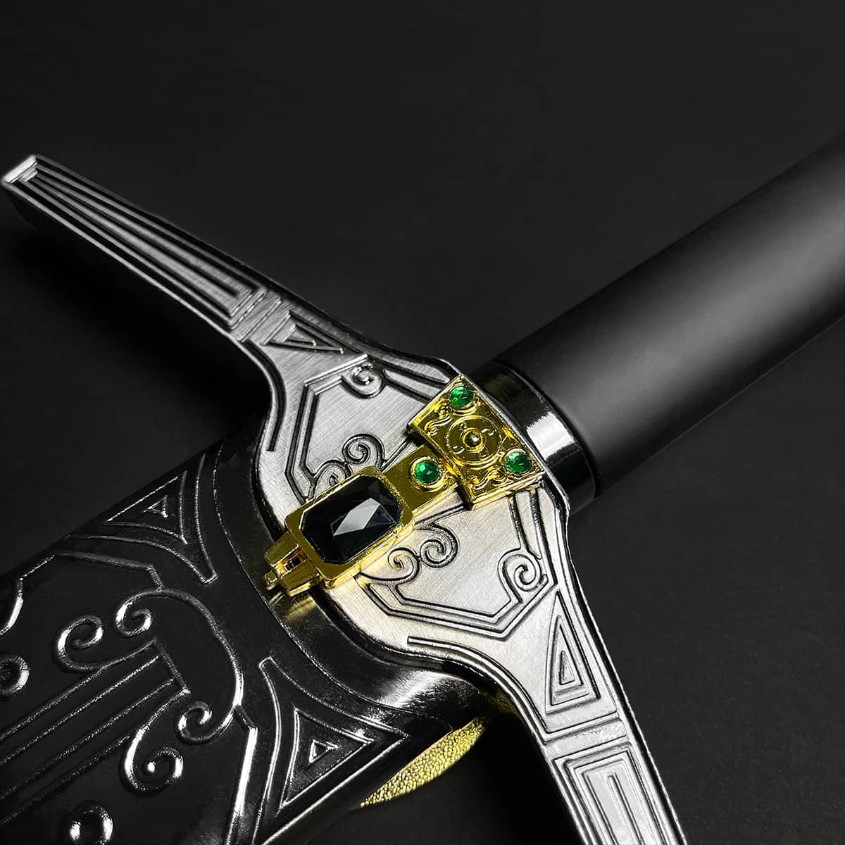 Knights Collection ornate medieval sword for sale closeup of silver engraved guard gold jeweled pommel and black grip
