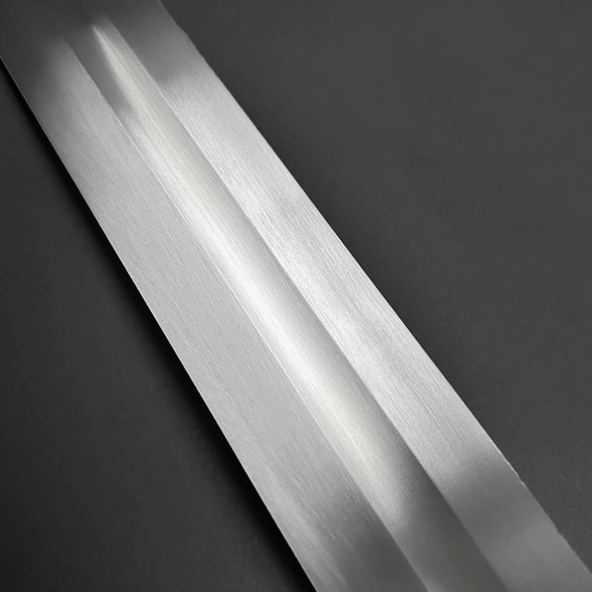 Knights Collection hand-forged viking longsword polished blade detail with central fuller on dark background