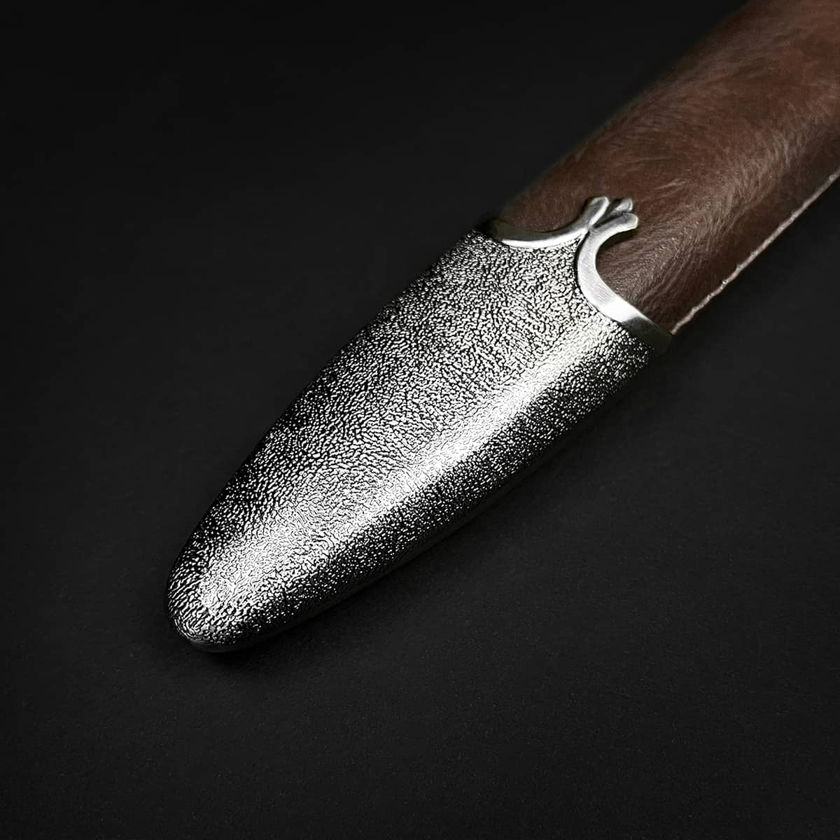 Knights Collection polycephally medieval sword leather scabbard close up showing textured metal chape and brown grip