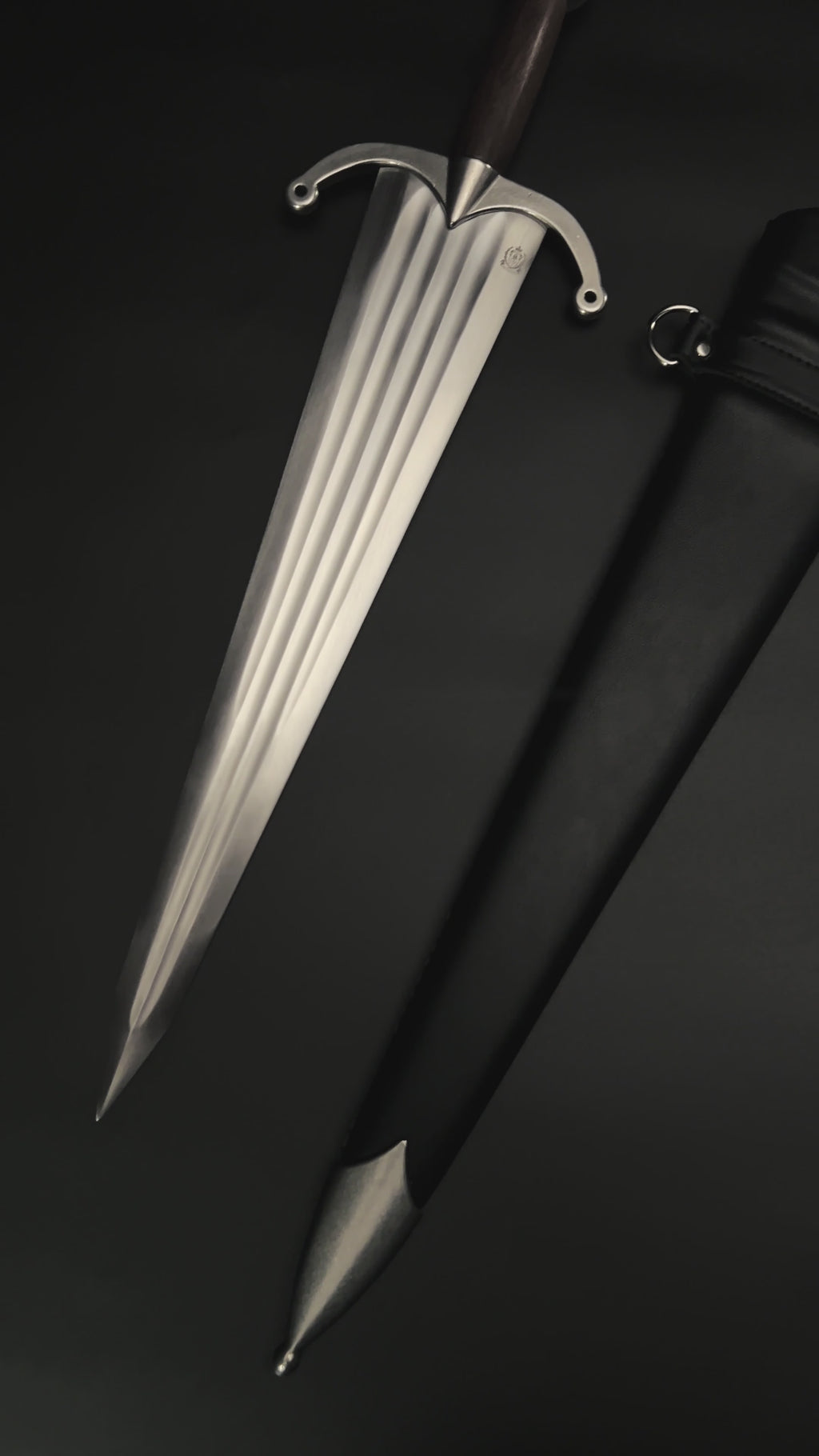 Medieval knight dagger with broad blade and black scabbard