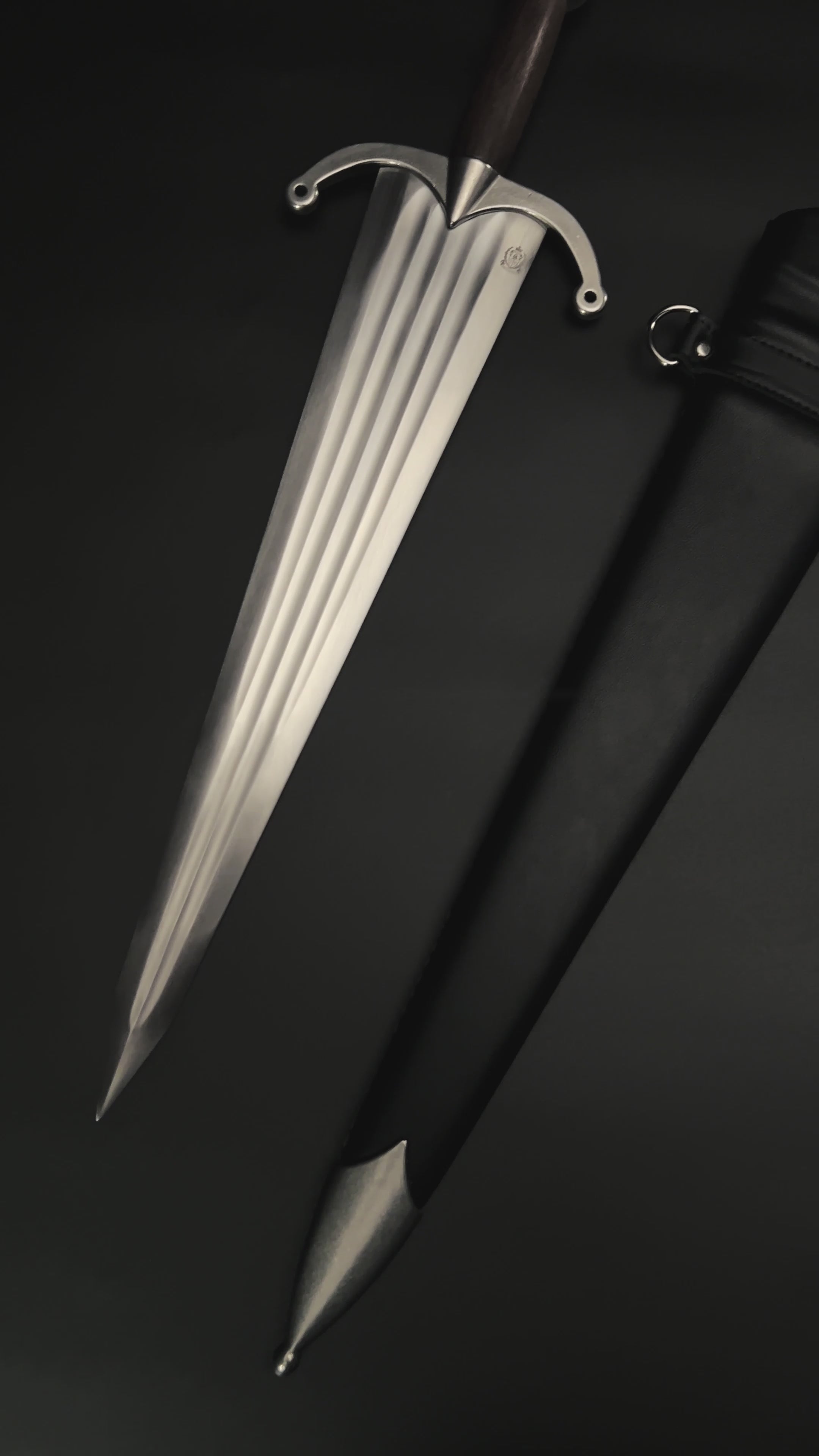 Medieval knight dagger with broad blade and black scabbard