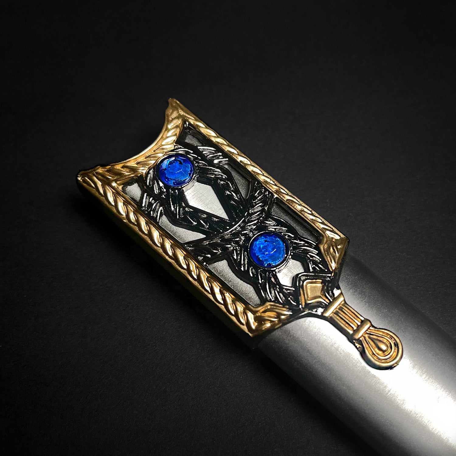 Roman Dagger with Intricate Handle Design and Blue Gem Accents