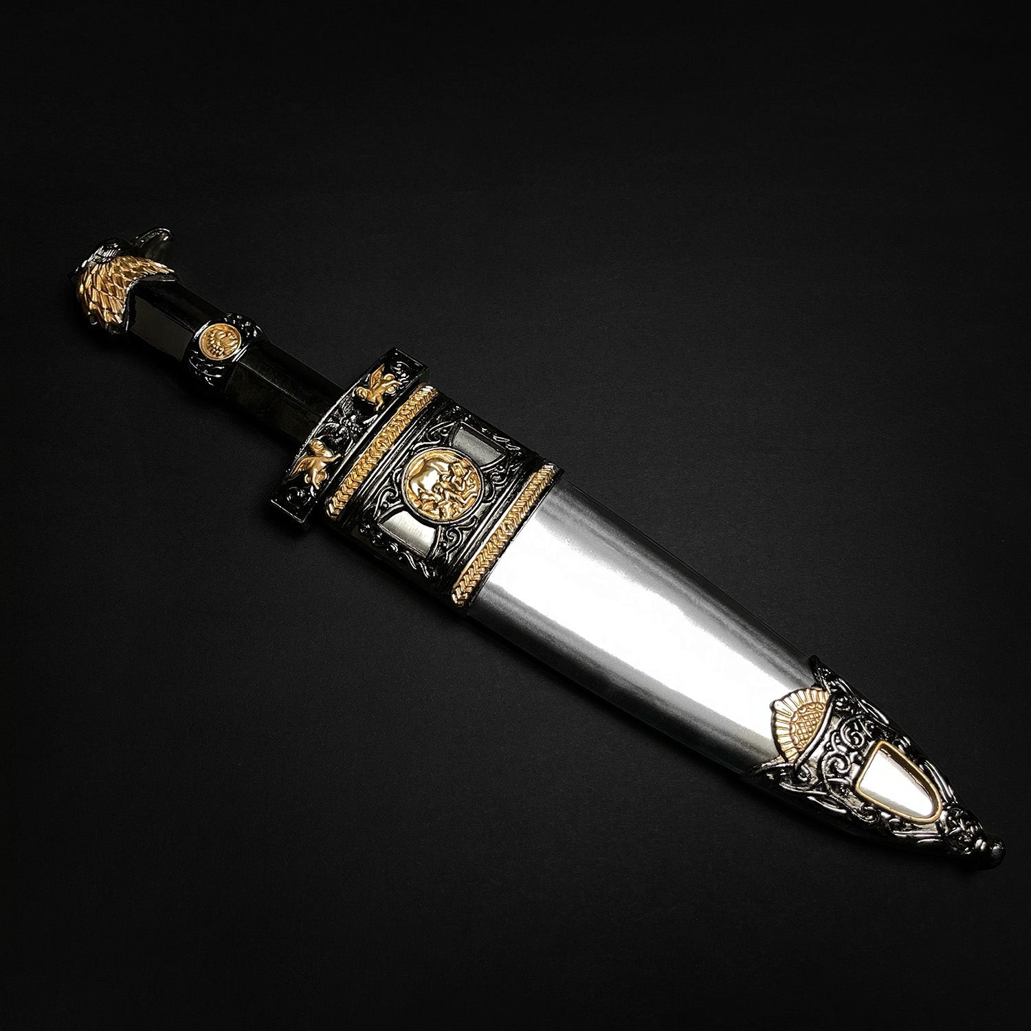 Roman Dagger with Intricate Black and Gold Handle Design and Polished Blade