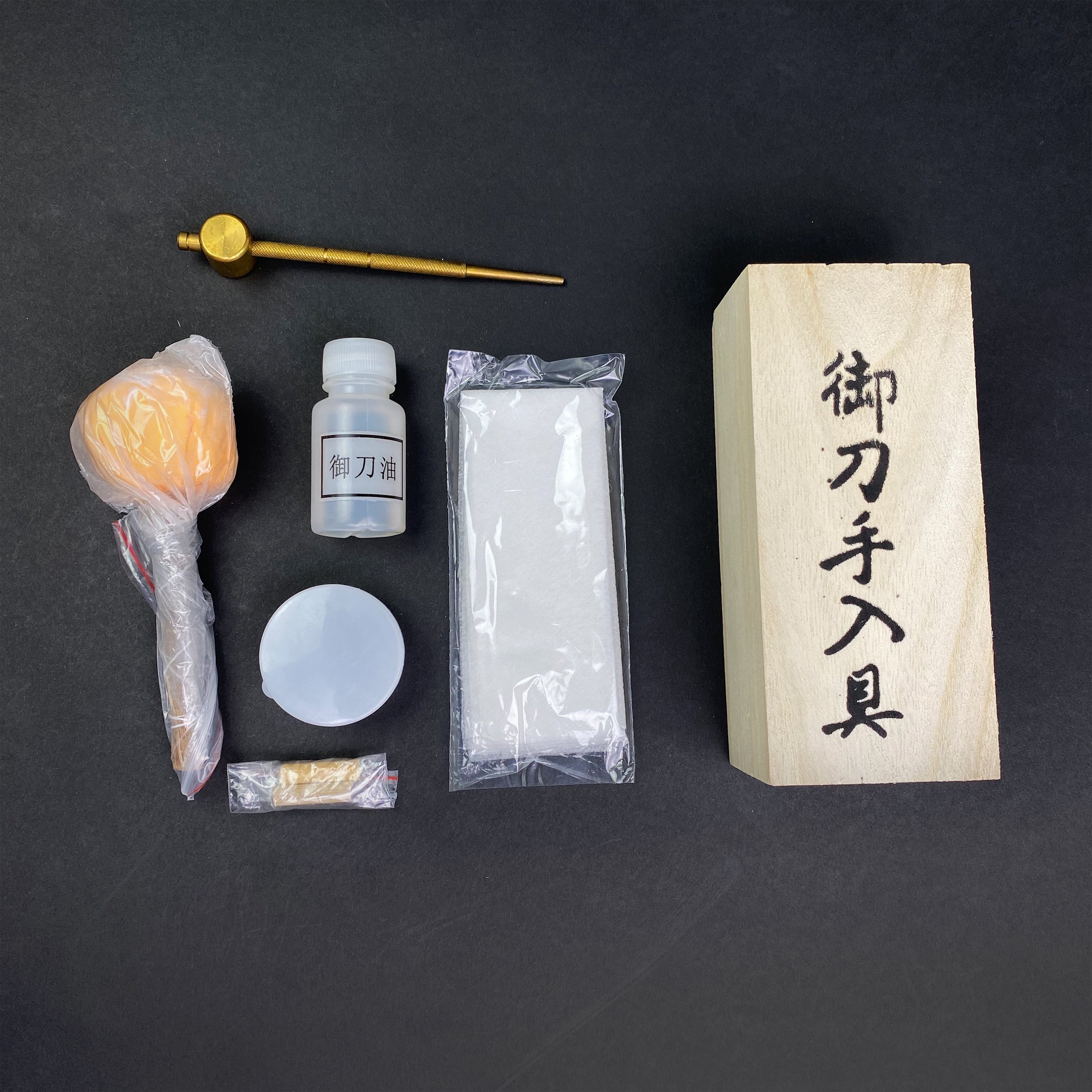 Knight's Collection Sword Cleaning Kit featuring oil, cleaning cloth, and tools for sword maintenance
