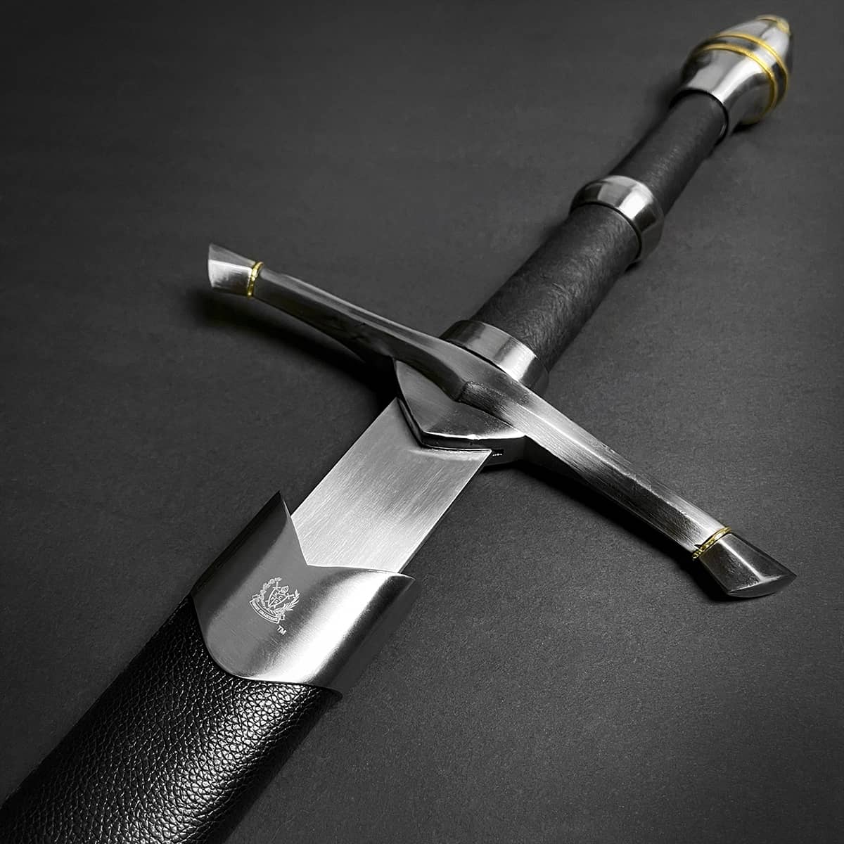 Medieval sword for sale with detailed steel guard and black leather handle from Knight's Collection